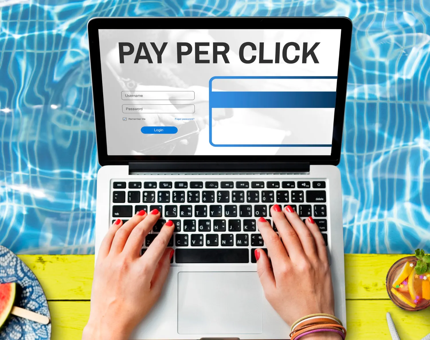 Hands typing on laptop with 'Pay Per Click' login screen