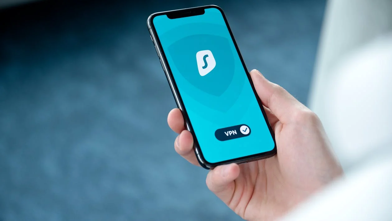 Smartphone with active VPN app showing S shield logo.