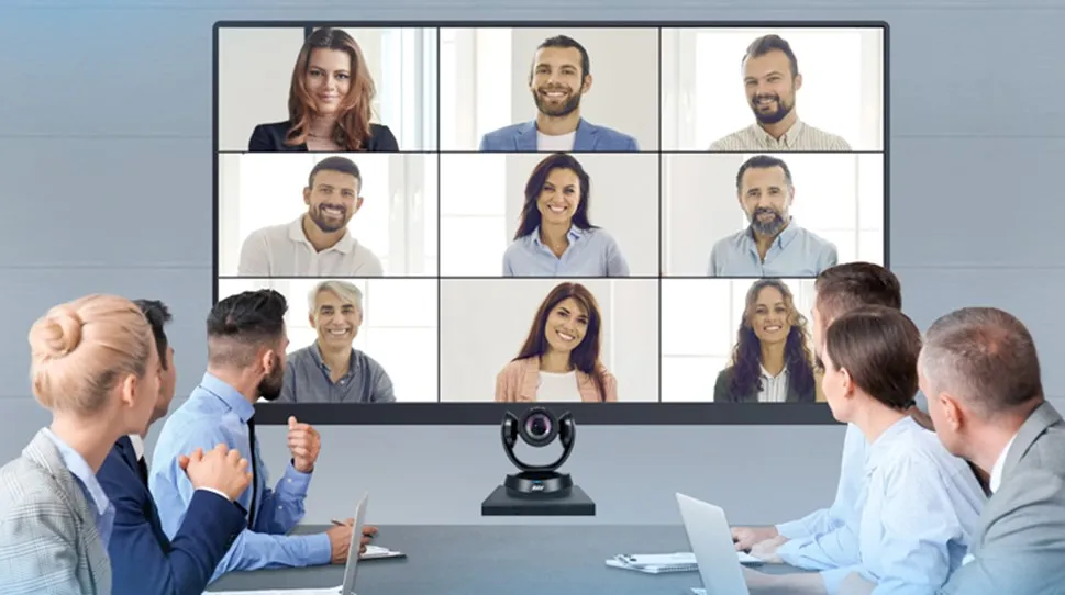 Team attending a virtual meeting via video conference on a screen.