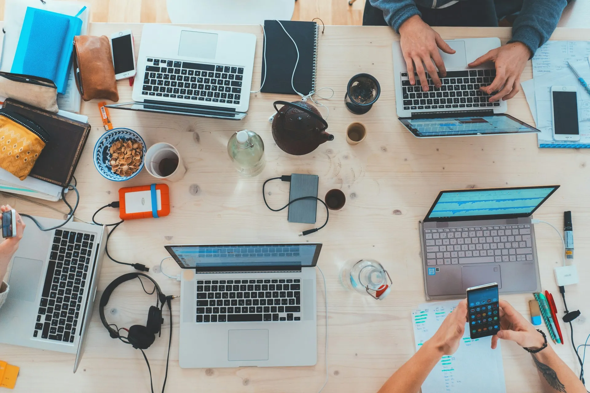 Aerial view of team working on laptops in cozy modern office.