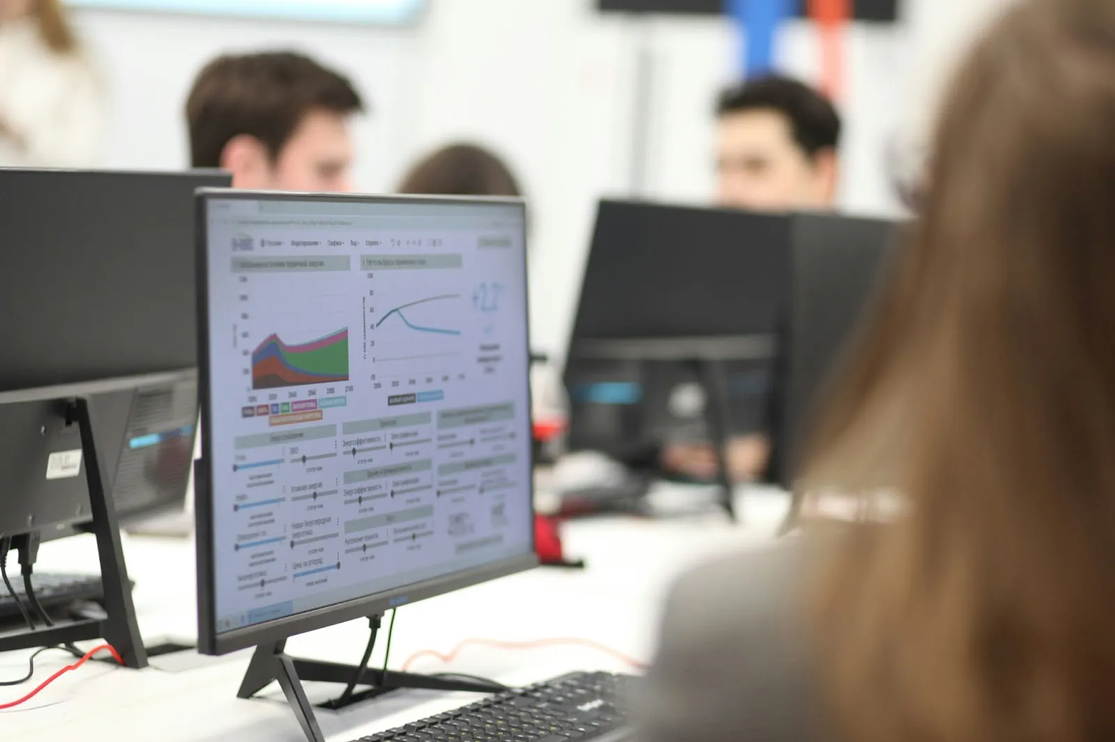 Colorful data dashboard displayed on computer in busy office